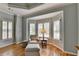 Bedroom sitting area with bay windows and comfortable furnishings, hardwood floors at 955 Bishopswood Pl, Johns Creek, GA 30022