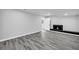 Finished basement area with plank flooring, fireplace, and access to outdoors, perfect for entertaining at 175 Montego Cir, Riverdale, GA 30274