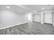 Finished basement features plank flooring, recessed lighting, and ample space for various activities at 175 Montego Cir, Riverdale, GA 30274