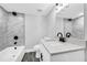 Bathroom featuring tiled shower, gray wood-look flooring, and modern fixtures at 175 Montego Cir, Riverdale, GA 30274