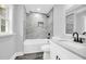 Modern bathroom featuring a tub and shower with gray marble-style tile, with a gray floor, and a modern sink at 175 Montego Cir, Riverdale, GA 30274