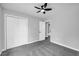 Spacious bedroom featuring neutral walls, carpeted flooring, a ceiling fan, and a closet at 175 Montego Cir, Riverdale, GA 30274