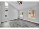 Bright bedroom with plank flooring, neutral walls, and natural light from multiple windows at 175 Montego Cir, Riverdale, GA 30274