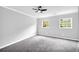 Bedroom with two windows, ceiling fan, and plush gray carpeting at 175 Montego Cir, Riverdale, GA 30274