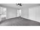Spacious bedroom featuring carpeted flooring, gray walls, a ceiling fan, and an ensuite bathroom at 175 Montego Cir, Riverdale, GA 30274