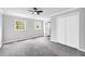 Bedroom with neutral paint, gray carpet, and multiple windows for natural light at 175 Montego Cir, Riverdale, GA 30274