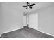 Spacious bedroom featuring gray walls, carpeted flooring, a ceiling fan, and a closet with white doors at 175 Montego Cir, Riverdale, GA 30274