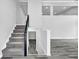 Spacious foyer with staircase, gray plank flooring, and bright lighting for a modern, inviting entry at 175 Montego Cir, Riverdale, GA 30274