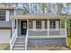 Cozy front porch features gray stone accents and white railing, with entry door and well-maintained landscaping at 175 Montego Cir, Riverdale, GA 30274