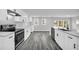 Kitchen featuring white cabinets, stone countertops, and gray flooring at 175 Montego Cir, Riverdale, GA 30274