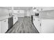 Spacious kitchen featuring gray floors, white cabinets, quartz countertops, stainless steel dishwasher and black appliances at 175 Montego Cir, Riverdale, GA 30274