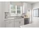 A close-up of the kitchen sink area, showcasing modern fixtures and natural light from the window at 522 Provence Gate Ln, Lawrenceville, GA 30044