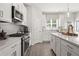 Bright eat-in kitchen features white cabinets, stainless steel appliances, and a large center island at 522 Provence Gate Ln, Lawrenceville, GA 30044