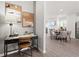Inviting living area featuring hardwood floors, a modern desk and decor, and an adjacent dining space at 522 Provence Gate Ln, Lawrenceville, GA 30044