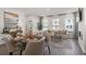 Open-concept living room features a modern sofa, fireplace, stylish decor, and eat-in kitchen at 522 Provence Gate Ln, Lawrenceville, GA 30044