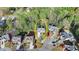 Aerial shot of home in residential neighborhood featuring a large driveway and mature trees at 5717 Harmony Point Dr, Lilburn, GA 30047