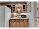 Home bar area with wooden cabinets, a sink, and a microwave at 5717 Harmony Point Dr, Lilburn, GA 30047