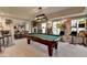 Spacious basement featuring a pool table, bar seating, and ample recreational space at 5717 Harmony Point Dr, Lilburn, GA 30047