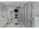 Bright bathroom features a seamless glass enclosed shower, tiled floors, and dual vanities at 5717 Harmony Point Dr, Lilburn, GA 30047