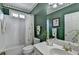 Bathroom with green walls, white shower, and lots of vanity space at 5717 Harmony Point Dr, Lilburn, GA 30047
