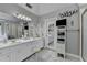 Bright bathroom features a double vanity, tiled floors, and a seamless glass enclosed shower at 5717 Harmony Point Dr, Lilburn, GA 30047