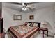 Cozy bedroom featuring neutral walls, ceiling fan, carpet, and a decorative quilt on the bed at 5717 Harmony Point Dr, Lilburn, GA 30047