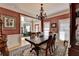 Dining room with mauve walls, hardwood flooring, and elegant wainscotting at 5717 Harmony Point Dr, Lilburn, GA 30047
