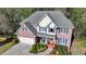 Charming two-story brick home with a well-manicured lawn and classic architectural details at 5717 Harmony Point Dr, Lilburn, GA 30047