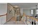 Upstairs hallway view with stairs and a railing with wood trim at 5717 Harmony Point Dr, Lilburn, GA 30047