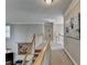 Upstairs hallway with carpet, crown molding, and access to bedrooms and bathrooms at 5717 Harmony Point Dr, Lilburn, GA 30047