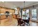 Bright kitchen features stainless appliances, island, and a cozy breakfast nook with natural lighting at 5717 Harmony Point Dr, Lilburn, GA 30047
