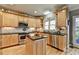 Kitchen view with wood cabinets, stainless appliances and dark countertops at 5717 Harmony Point Dr, Lilburn, GA 30047