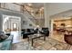 Bright and open living room featuring hardwood floors, a staircase, and comfortable seating at 5717 Harmony Point Dr, Lilburn, GA 30047