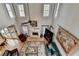 Living room with large windows, ceiling fan, and fireplace at 5717 Harmony Point Dr, Lilburn, GA 30047