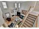 Open-concept living room with high ceilings, fireplace, and large windows offering plenty of natural light at 5717 Harmony Point Dr, Lilburn, GA 30047