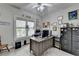 Well-lit home office with a large window, filing cabinets, and gray desk at 5717 Harmony Point Dr, Lilburn, GA 30047