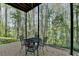 Covered patio featuring dining set and scenic view at 5717 Harmony Point Dr, Lilburn, GA 30047