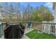 Outdoor back deck with grill, chair and wooded background at 6389 Shadow Sq, Lithonia, GA 30058