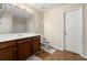 Bright bathroom with white countertop, wood cabinets, and a large mirror at 6389 Shadow Sq, Lithonia, GA 30058