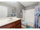Cozy bathroom featuring a vanity with double sinks, toilet, and shower-tub combo at 6389 Shadow Sq, Lithonia, GA 30058