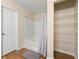 Bathroom featuring shower-tub combo and storage shelves, with tile flooring at 6389 Shadow Sq, Lithonia, GA 30058