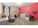 Charming Bedroom with pink accent wall, alphabet rug, and ample natural light at 6389 Shadow Sq, Lithonia, GA 30058