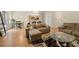 Inviting living room with hardwood floors, a cozy sectional sofa, and an open floor plan at 6389 Shadow Sq, Lithonia, GA 30058
