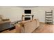 Comfortable living room with a sleek entertainment center, hardwood floors, and neutral decor at 6389 Shadow Sq, Lithonia, GA 30058