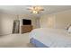 Bright primary bedroom with large bed, tv, closet door and plush carpet at 6389 Shadow Sq, Lithonia, GA 30058