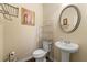 Well-appointed powder room with a pedestal sink, stylish fixtures, and a decorative mirror at 6389 Shadow Sq, Lithonia, GA 30058