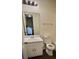 Clean bathroom with a single sink vanity, toilet, and tiled shower at 849 Cadet Nw Ct, Lilburn, GA 30047