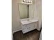 Bathroom featuring a white vanity with a mirror and dark-toned laminate flooring at 849 Cadet Nw Ct, Lilburn, GA 30047