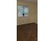 Bedroom showcasing a window overlooking foliage, and neutral carpeting at 849 Cadet Nw Ct, Lilburn, GA 30047