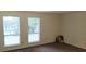 Bright bedroom with neutral walls, plush carpet and two large windows at 849 Cadet Nw Ct, Lilburn, GA 30047